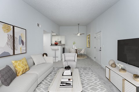 a living room with a white couch and a television